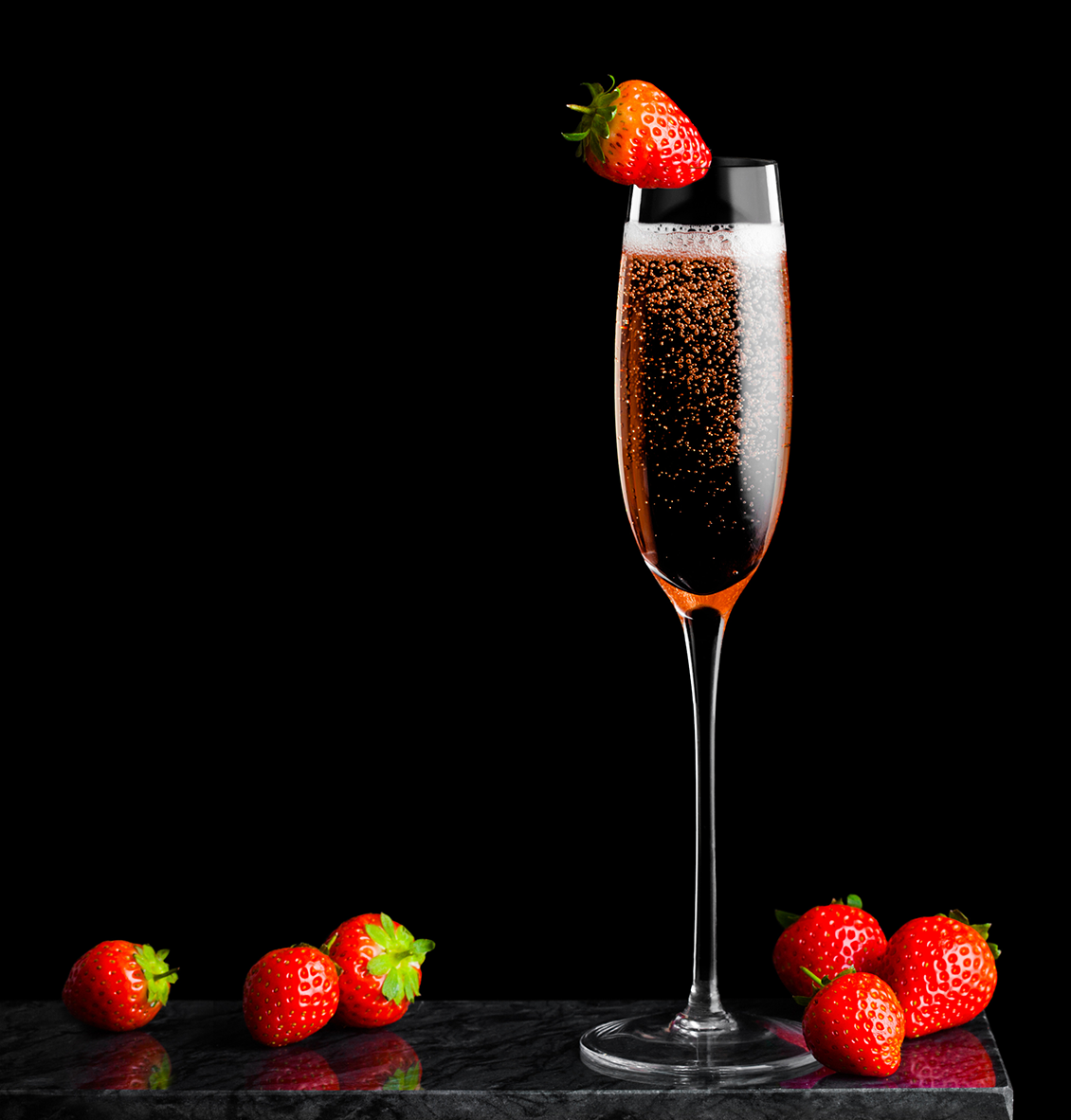 A glass of Champagne rosé with strawberries