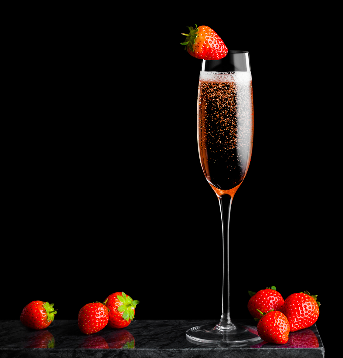 A glass of Champagne rosé with strawberries A glass of Champagne rosé with strawberries