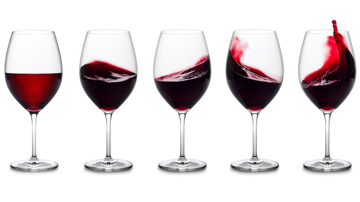 Red wine glasses with splashes of wine